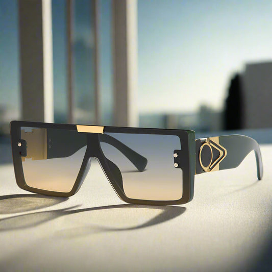 Sunglasses with black frame and gold accents on a white background